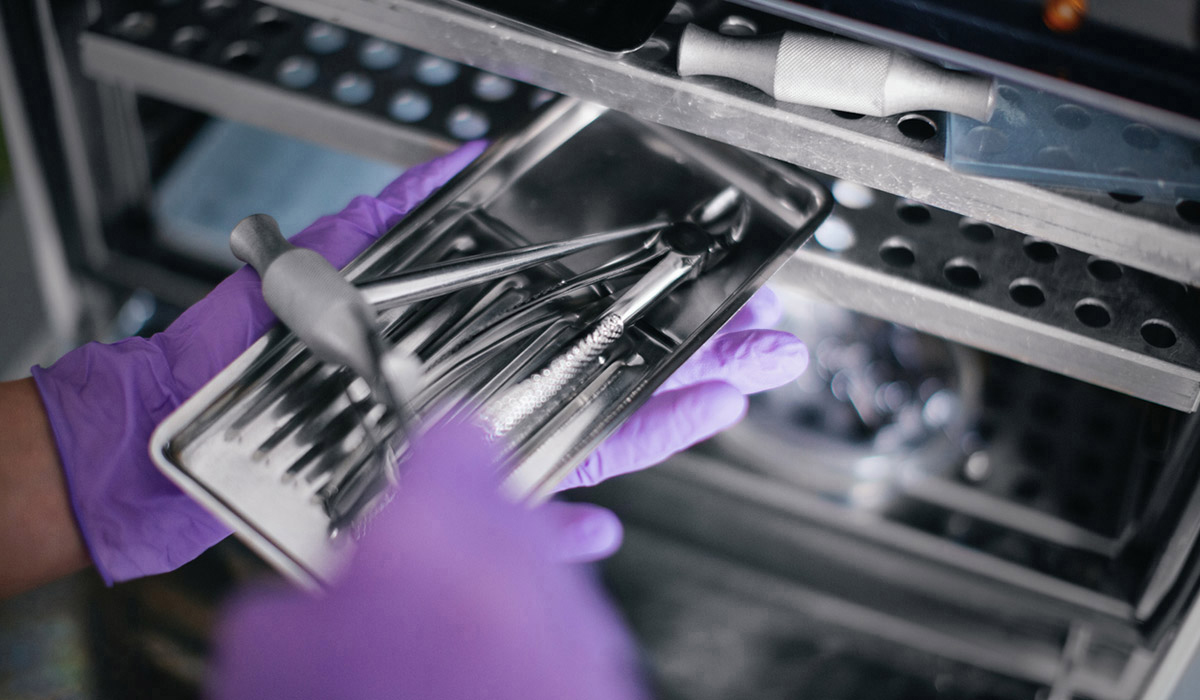 Medical instruments  being used  by medical personnel with purple glove