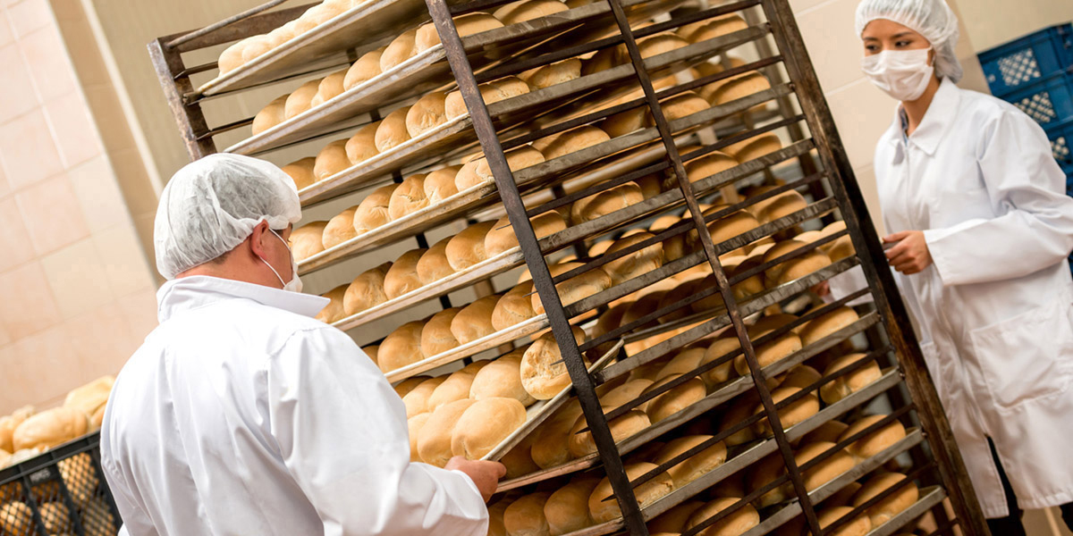 Bakers lifting break from sheet pan racks