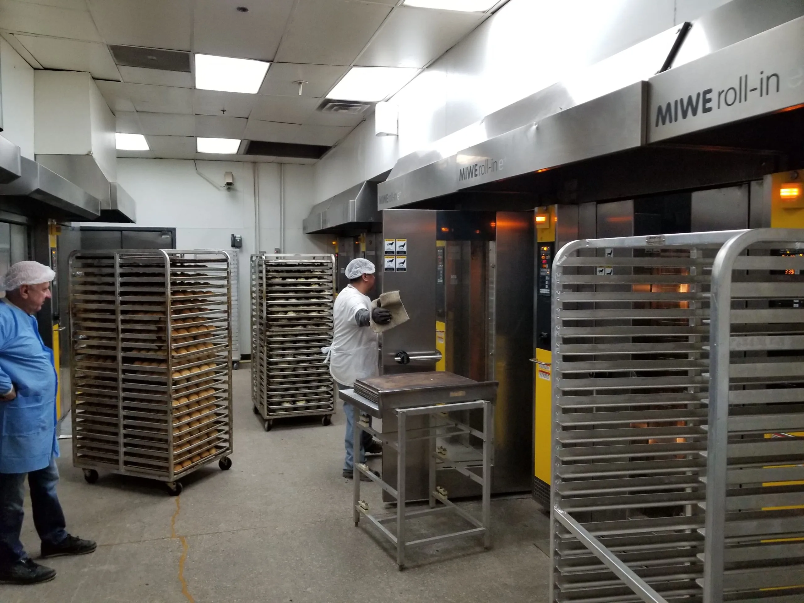 sheet pan racks being used in industrial kitchen