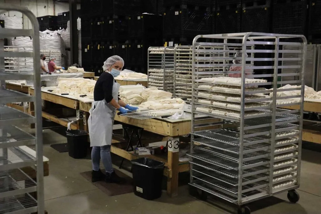 factory worker baking with shopcraft racks