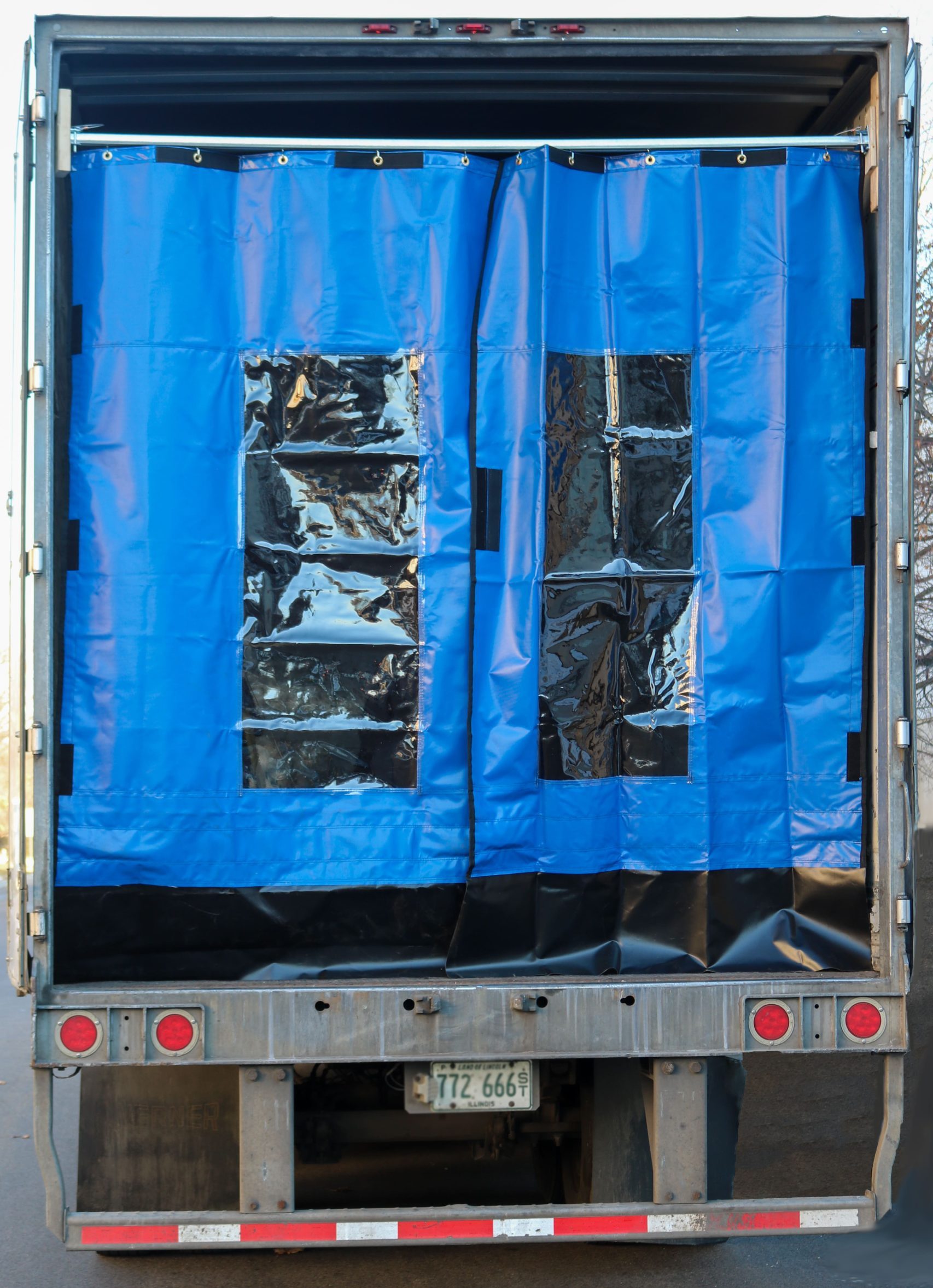 Refrigerated truck being efficiently loaded/unloaded with Schaumburg Specialties’ premium Refrigerated Truck Curtains in use, helping to ensure optimal temperature control for perishable goods inside the trailer.