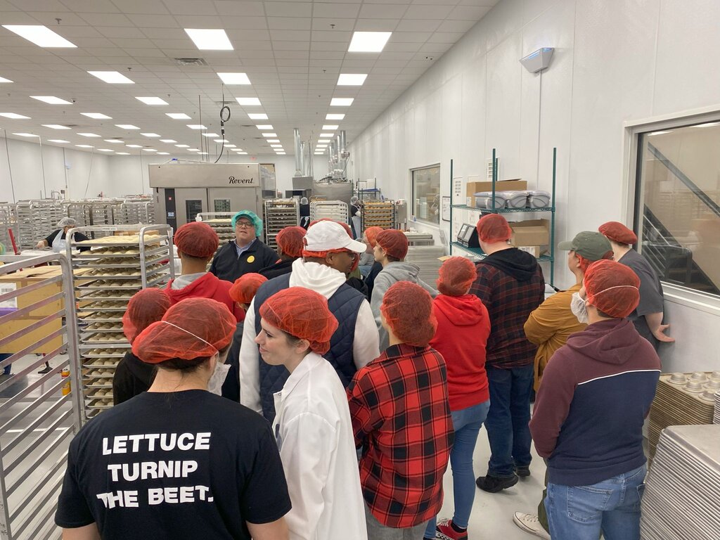 Employees and Sheet Pan Racks in Food Production