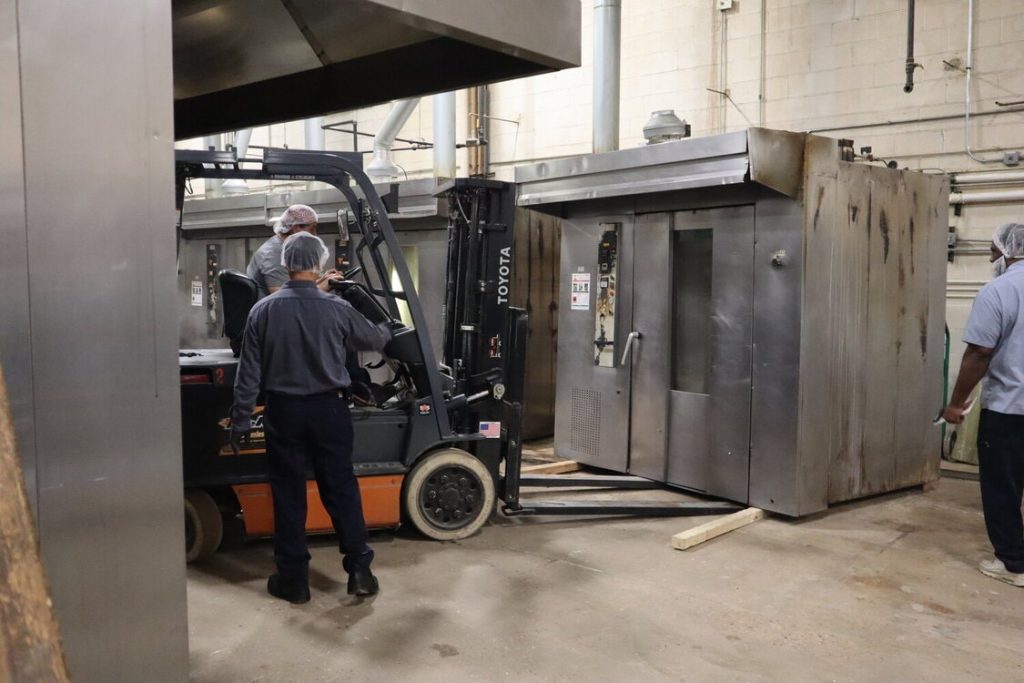 Forklift removing old bakery oven